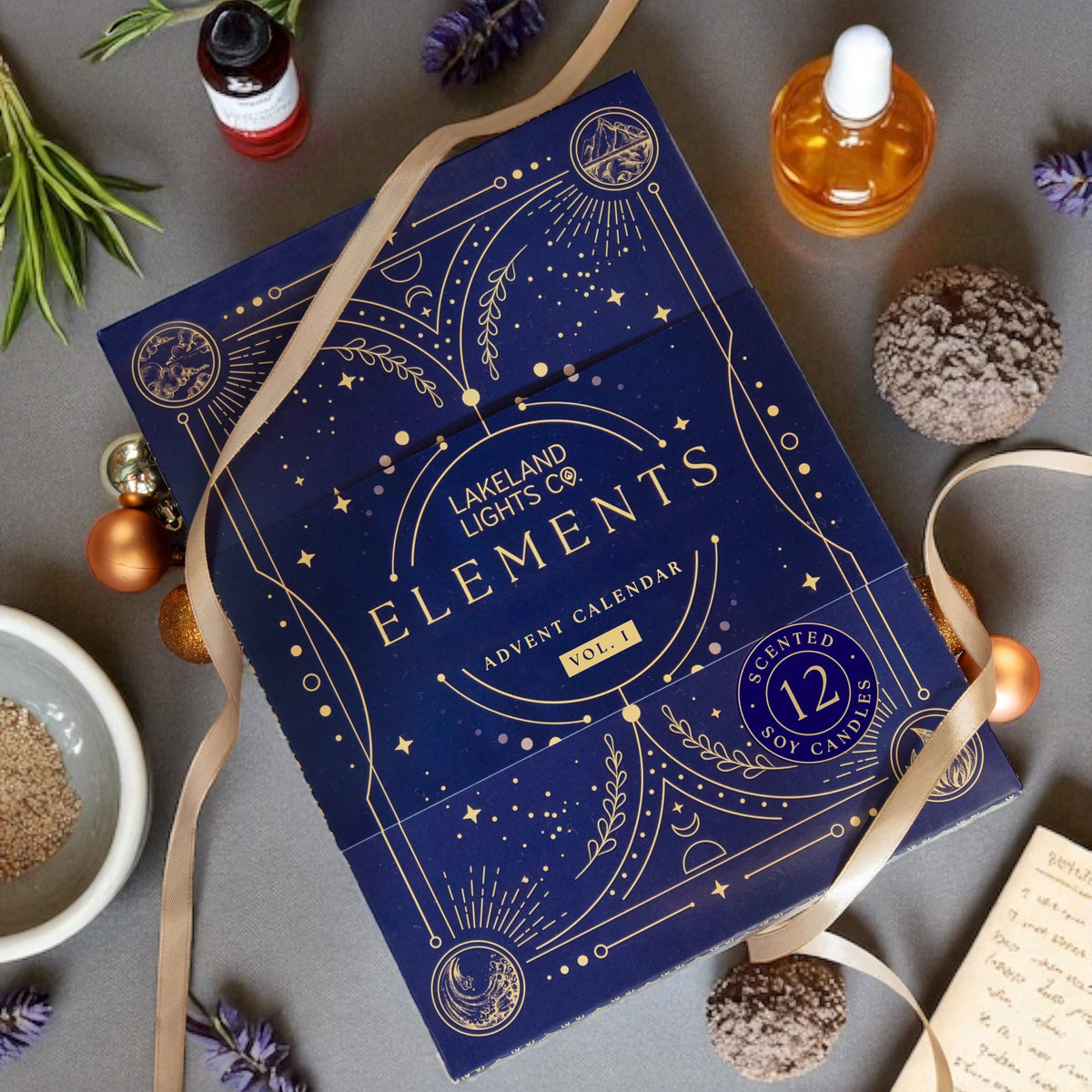 Advent calendar with 'Elements' design on a gray surface with decorative items.