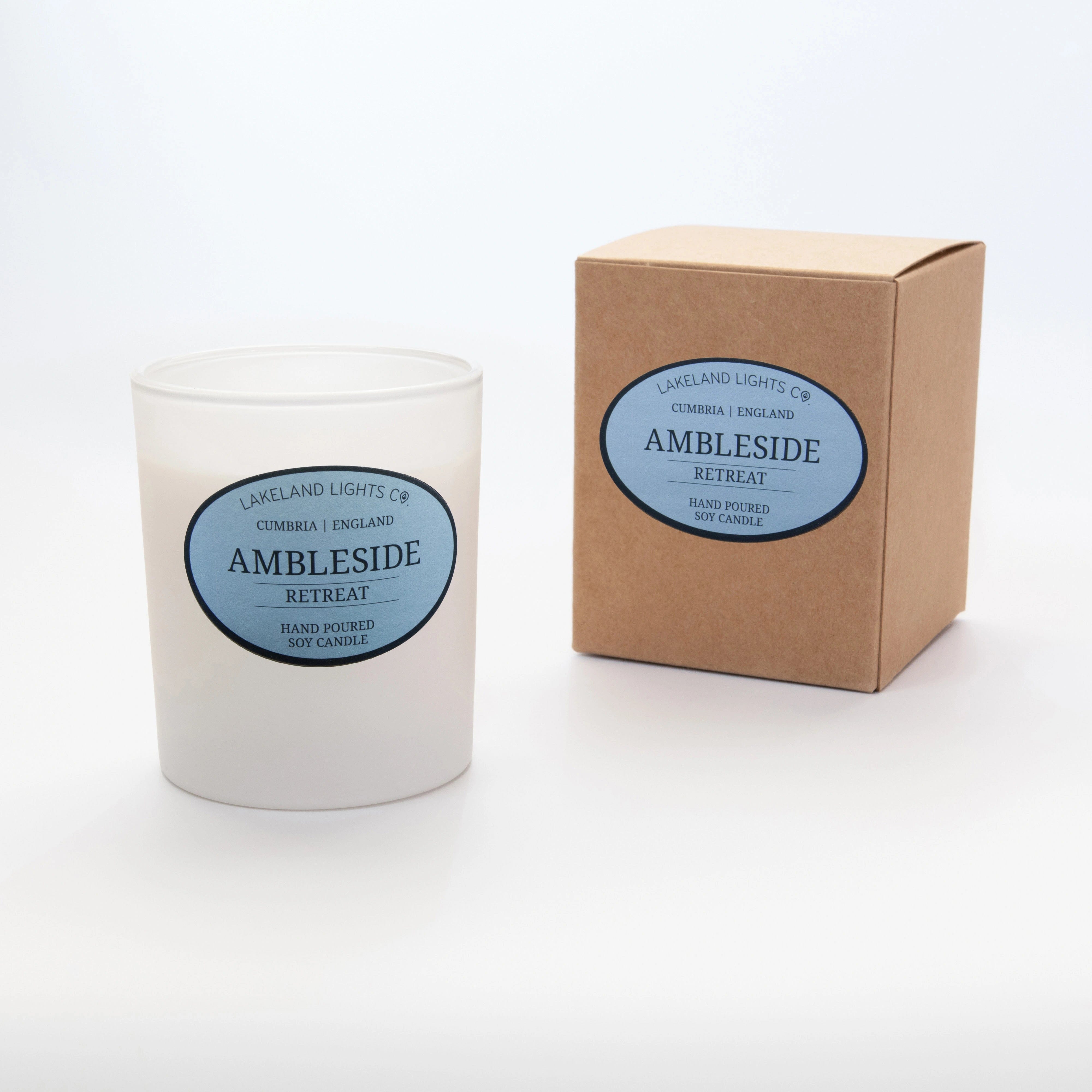 Ambleside Retreat soy candle by Lakeland Lights, featuring lavender, lemon, and jasmine scent, next to its kraft recyclable packaging box.