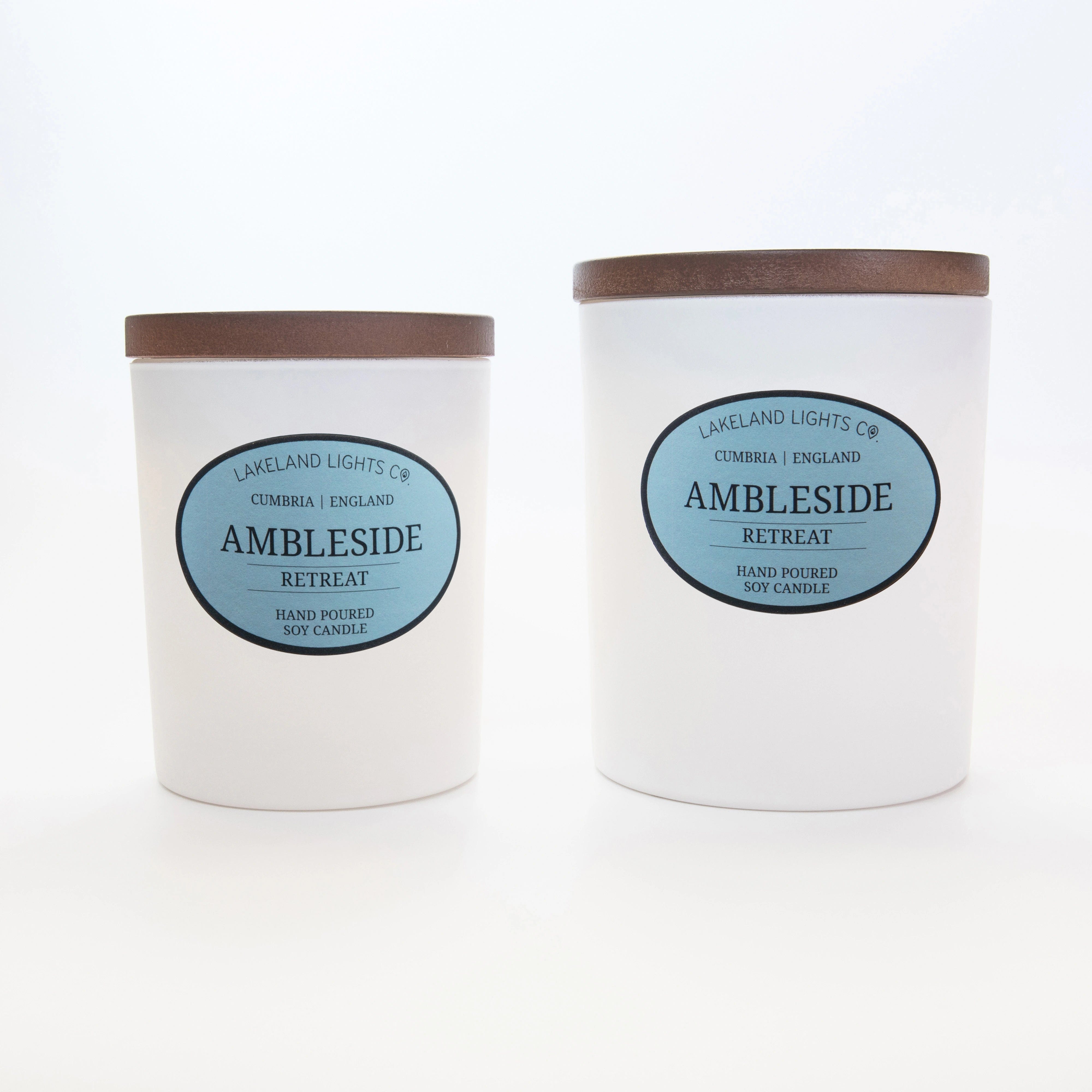 Two Ambleside Retreat soy candles by Lakeland Lights, featuring lavender, lemon, and jasmine scent, medium and large sizes side by side.