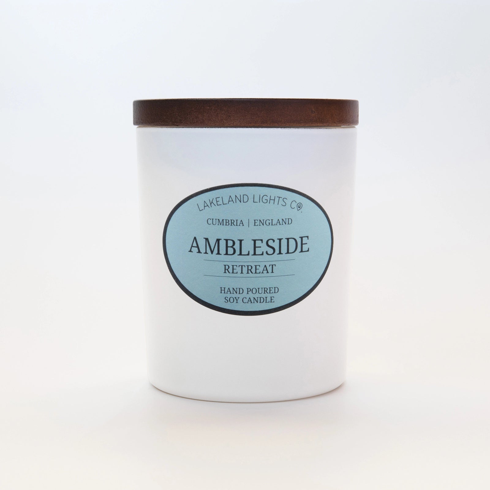 Ambleside Retreat soy candle by Lakeland Lights, featuring lavender, lemon, and jasmine scent, against a light blue background.